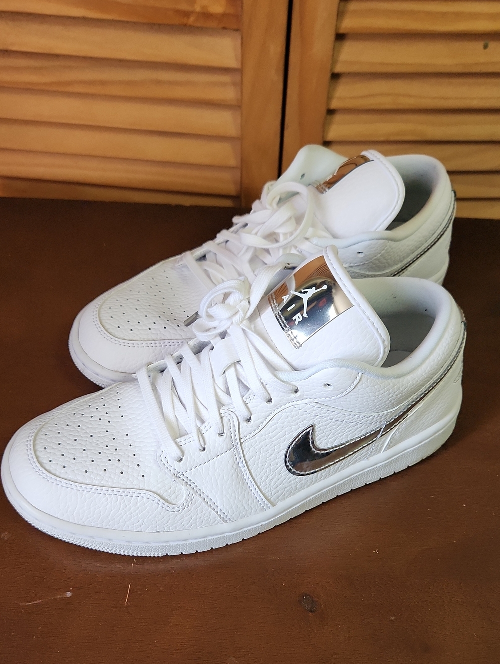 Nike White Low-Top Sneakers with Metallic Silver Swoosh